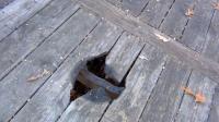 Hole in deck: Hole in deck caused by tenant using fire pit on a wooden deck.